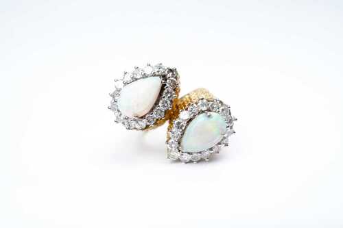 A vintage opal and diamond ring in 14 carat yellow gold