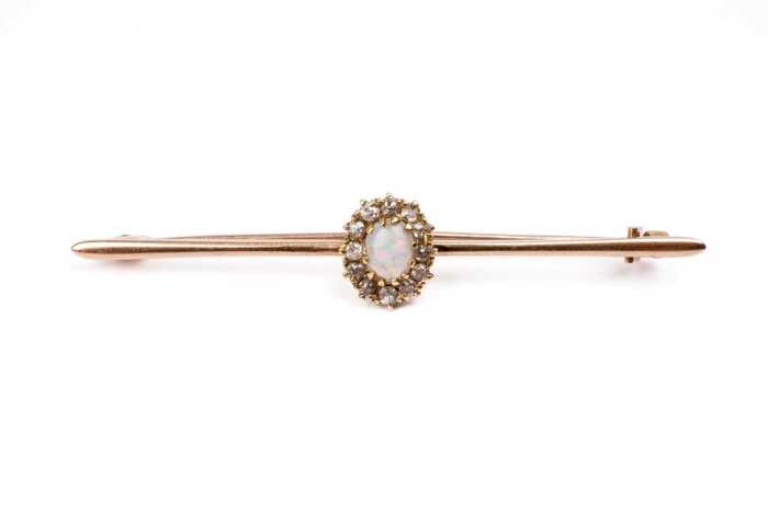 An antique opal and diamond brooch in 15 carat yellow gold