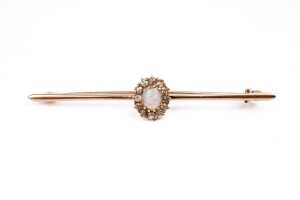 An antique opal and diamond brooch in 15 carat yellow gold