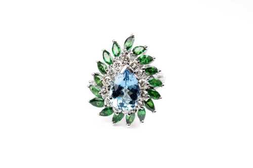 A aquamarine, tsavorite garnet and diamond ring in 14 carat white gold