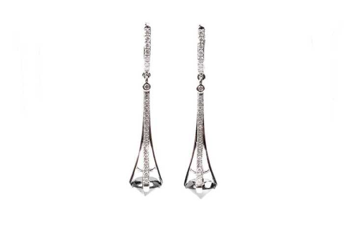 A pair of black and white diamond earrings