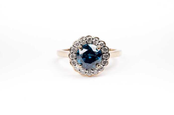 A treated blue and white diamond ring in 14 carat yellow gold