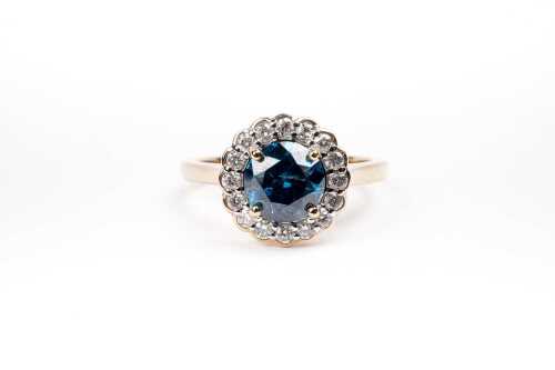 A treated blue and white diamond ring in 14 carat yellow gold
