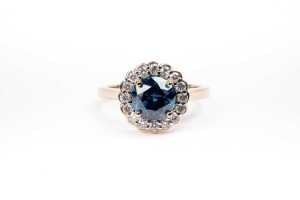 A treated blue and white diamond ring in 14 carat yellow gold