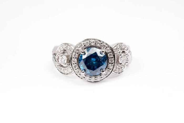 A treated blue and white diamond ring in 14 carat white gold