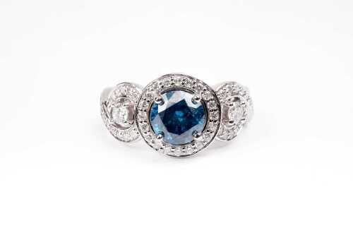 A treated blue and white diamond ring in 14 carat white gold