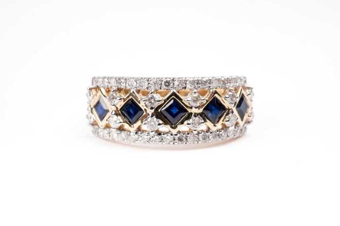 A sapphire and diamond ring in 14 carat yellow gold