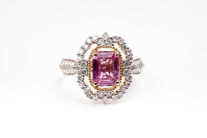 A pink sapphire and diamond ring in 14 carat yellow gold