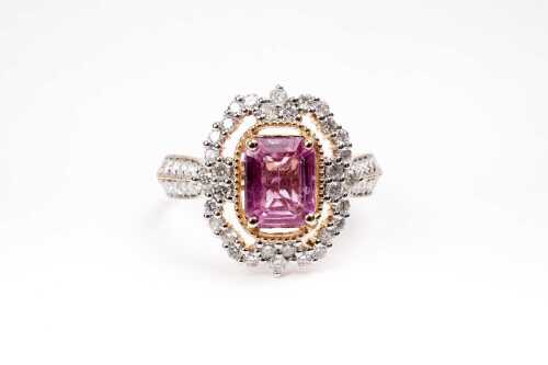 A pink sapphire and diamond ring in 14 carat yellow gold