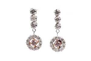 A pair of pink and white diamond earrings in 18 carat white and rose gold