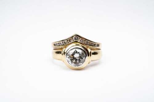 A diamond ring set in 18 carat yellow gold
