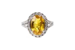 A yellow sapphire and diamond ring in 14 carat white gold