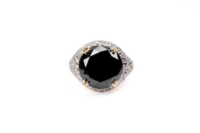 A black and white diamond ring in 14 carat yellow gold
