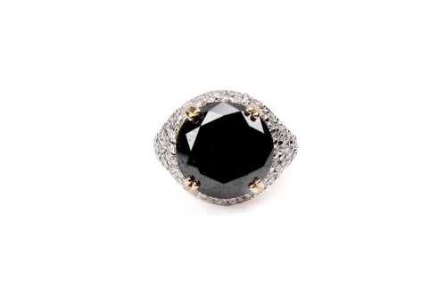 A black and white diamond ring in 14 carat yellow gold