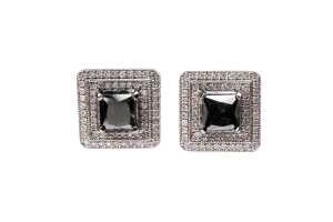 A pair of black and white diamond earrings in 14 carat white gold