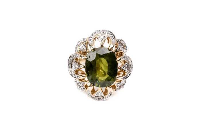 A green sapphire and diamond ring in 14 carat yellow gold