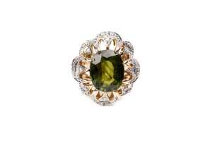 A green sapphire and diamond ring in 14 carat yellow gold