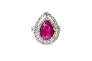 A ruby and diamond halo ring in 14 carat white gold
