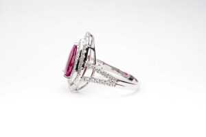 A ruby and diamond halo ring in 14 carat white gold - 2