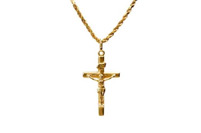 A crucifix in 18ct on a rope link necklace in 22ct yellow gold