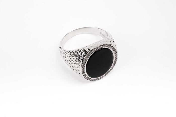 An onyx and diamond signet ring in 14 carat white gold