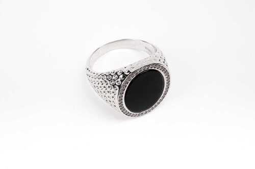 An onyx and diamond signet ring in 14 carat white gold