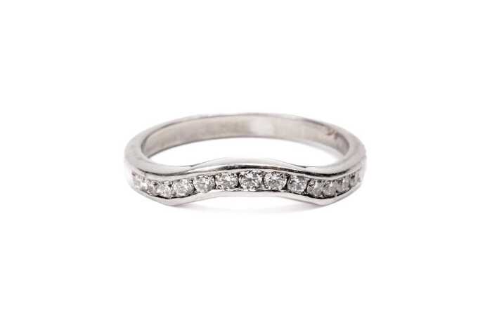 A diamond fitted wedding band in platinum