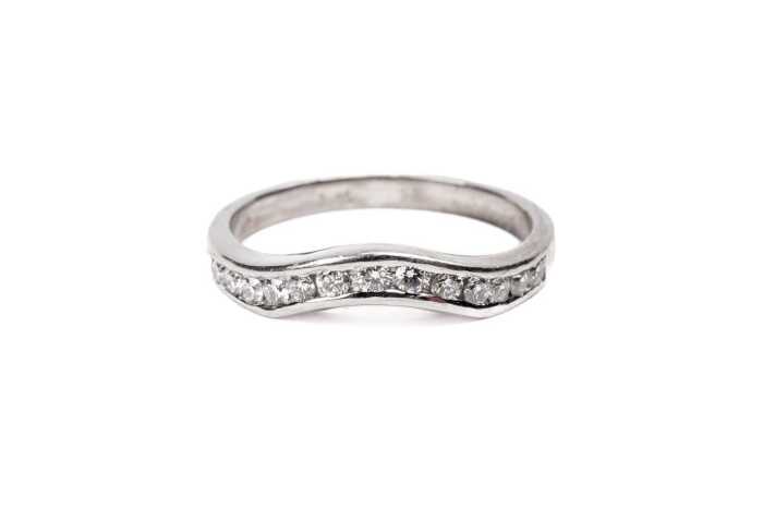 A diamond fitted wedding band in platinum