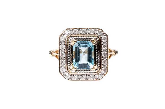 An aquamarine and diamond ring in 14 carat yellow gold