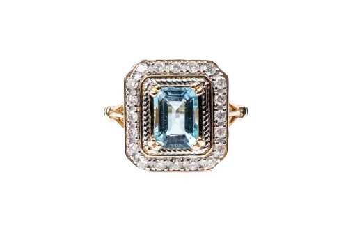 An aquamarine and diamond ring in 14 carat yellow gold