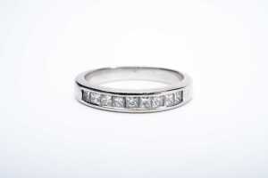 A princess cut diamond band in 18 carat white gold