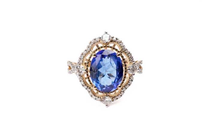 A tanzanite and diamond ring in 14 carat yellow gold