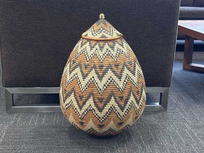 Hand-woven Zulu teardrop-shaped basket with geometric pattern