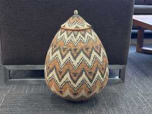 Hand-woven Zulu teardrop-shaped basket with geometric pattern
