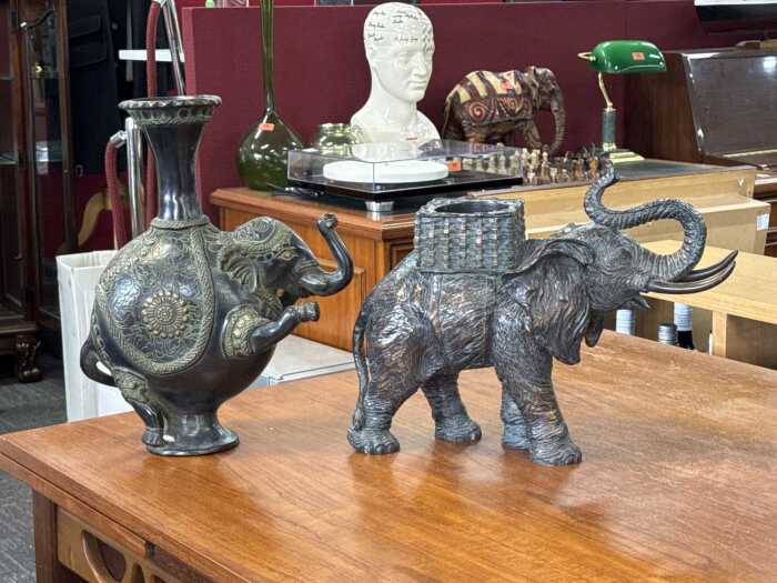 Two decorative elephants, one of which is a vase