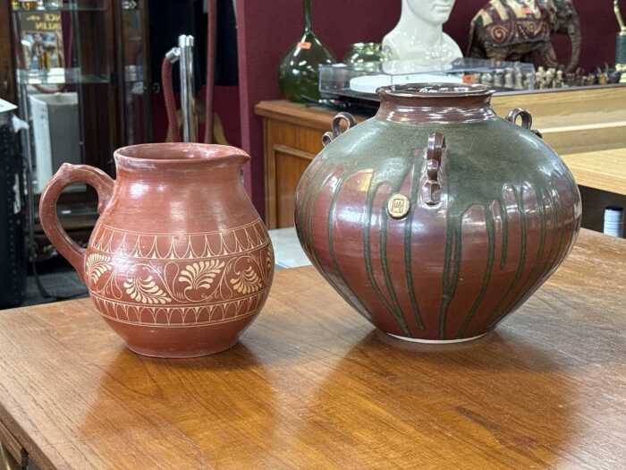 Two pieces of studio pottery including a tri-handled pot with drip glaze