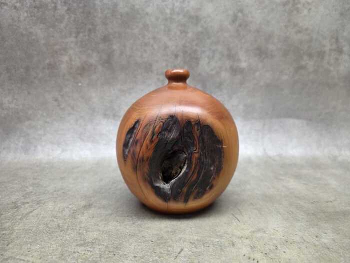 Hand-turned spherical Huon pine vase with natural knot detail