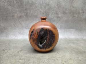 Hand-turned spherical Huon pine vase with natural knot detail