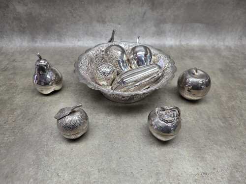 Collection of eight metal beetle nut boxes in a hammered and pieced bowl
