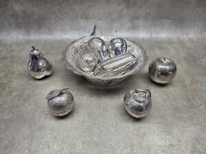 Collection of eight metal beetle nut boxes in a hammered and pieced bowl