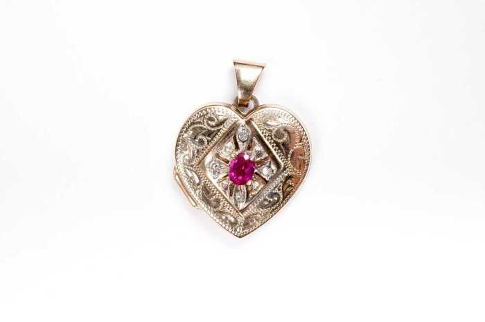 A ruby and diamond heart locket in 9 carat yellow gold