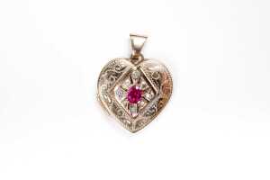 A ruby and diamond heart locket in 9 carat yellow gold