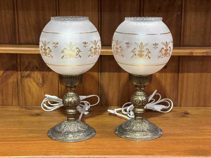 Pair of antique-style table lamps with metal bases and opaque glass shades