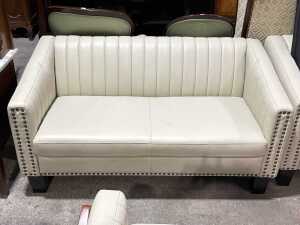 Contemporary cream upholstered two-seater sofa