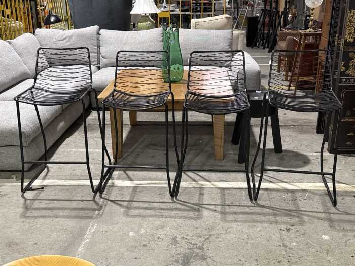 Set of four matte black metal wire bar stools