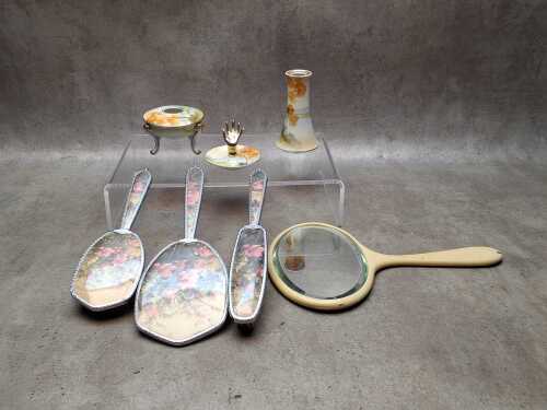 Vintage dressing table items including a brush set and porcelain trinket set.