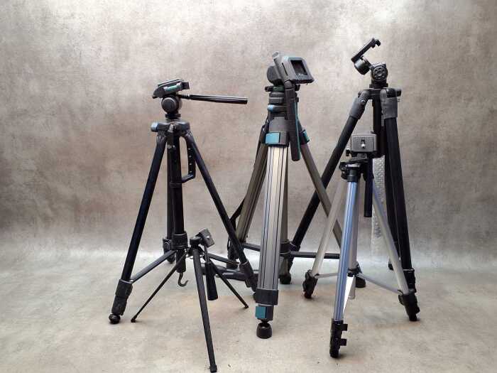 Five camera tripods with extendable legs including Optex