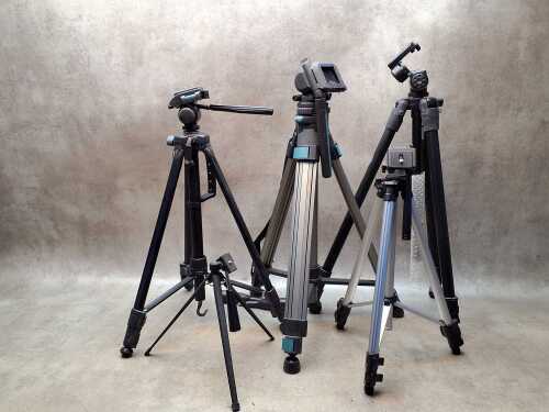 Five camera tripods with extendable legs including Optex
