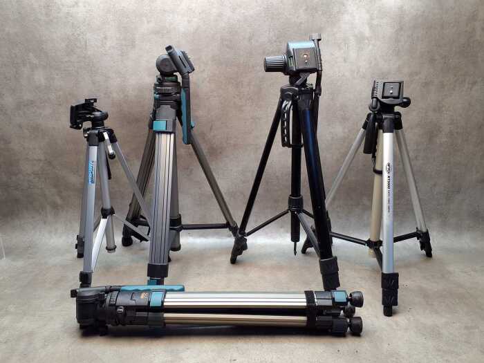 Five camera tripods with extendable legs including Optex