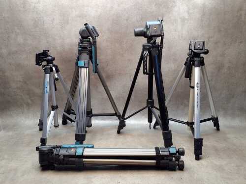 Five camera tripods with extendable legs including Optex